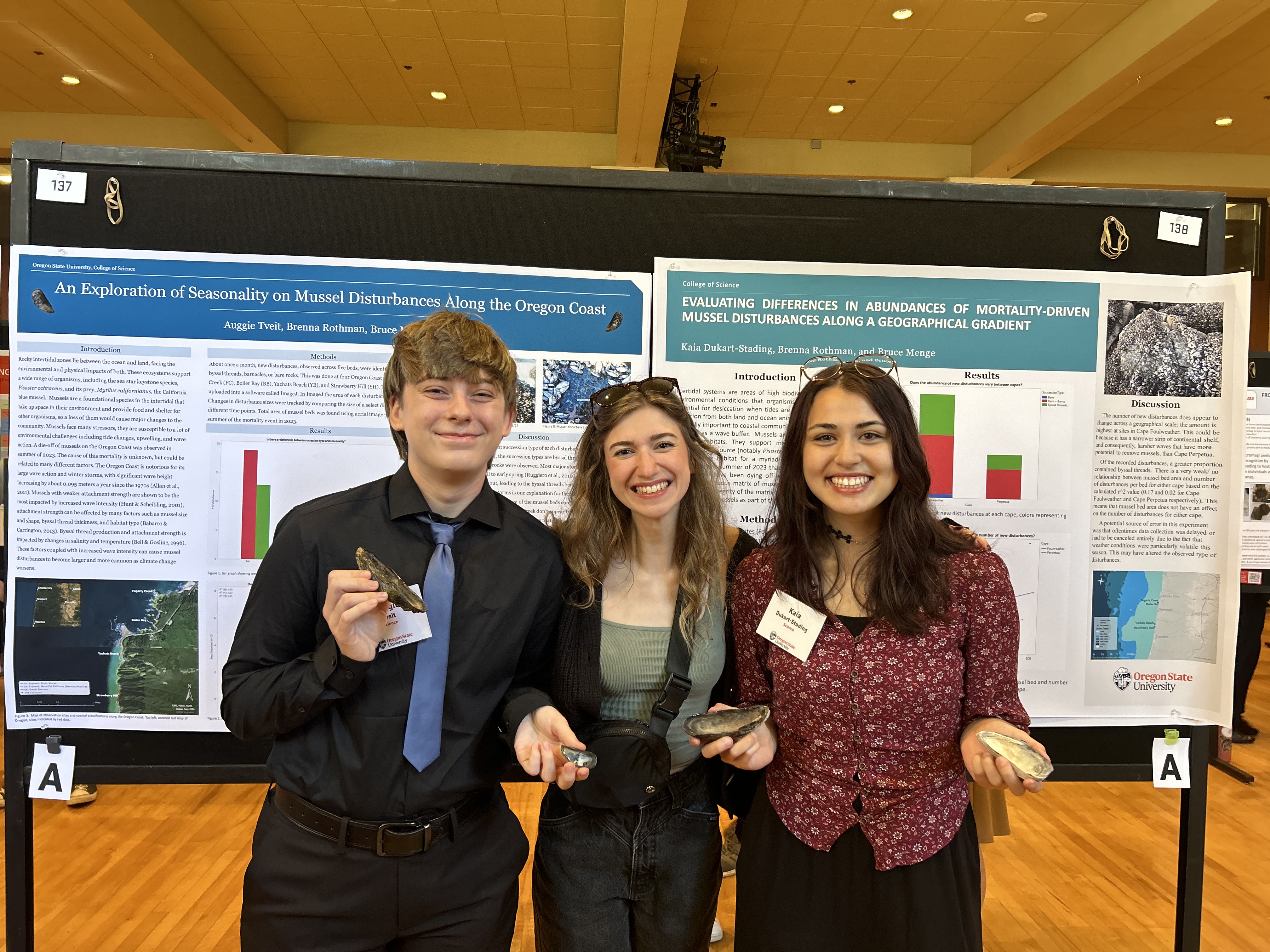 photo of undergraduate students Auggie (left) and Kaia (right) at a research symposium